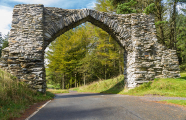 Obraz premium The Jubilee Arch, old graceful stone archway over minor road.