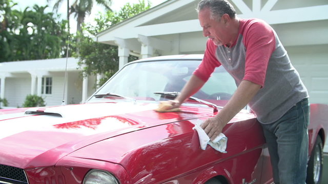 Retired Senior Man Cleaning Restored Classic Car 