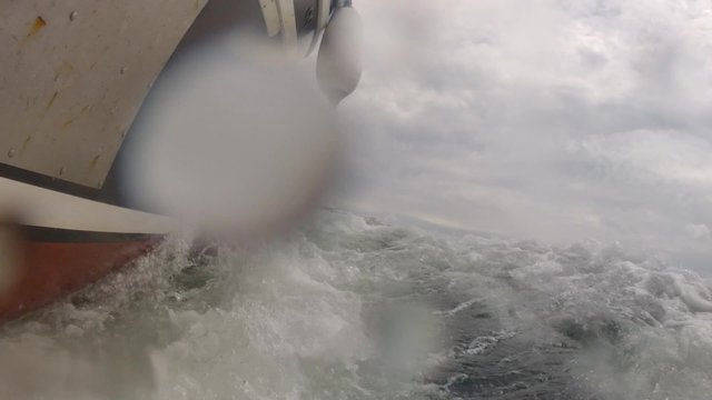 low shot of large fishing boat cruising through the ocean