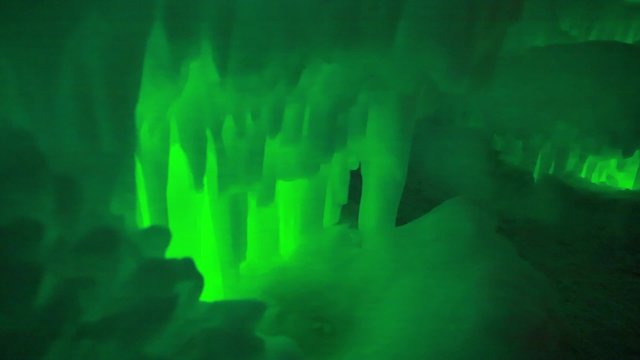 people walking around an ice castle in the winter