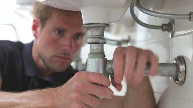 Plumber Working On Sink