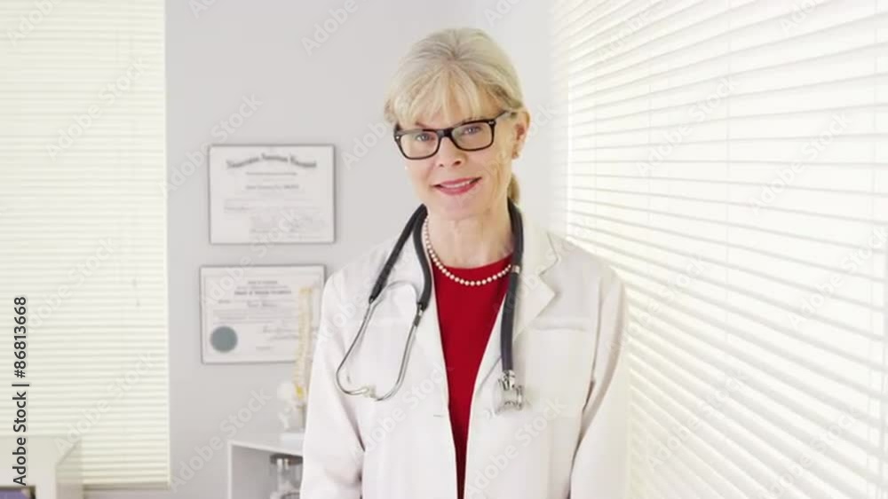 Wall mural Woman doctor smiling at camera