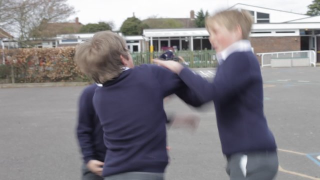 Three Boys Fighting In School Playground