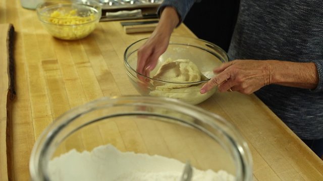 a woman letting dough rise to make orange rolls