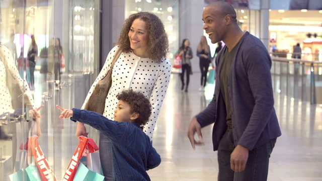 Child On Trip To Shopping Mall With Parents