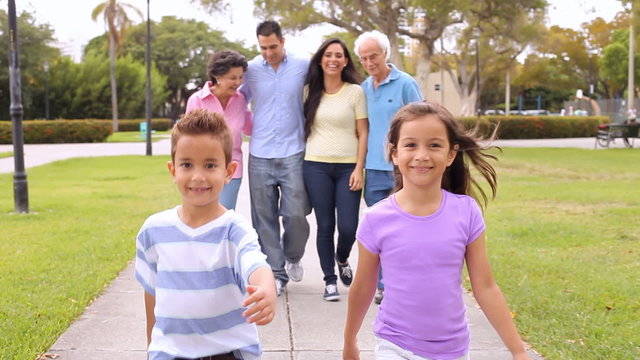 Multi Generation Hispanic  Family Walking In Park 