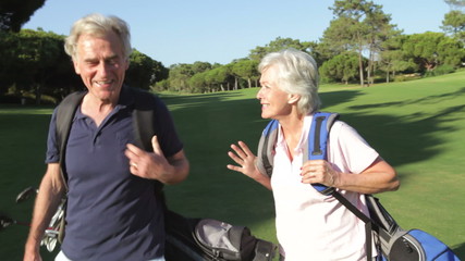 Senior Couple Enjoying Game Of Golf