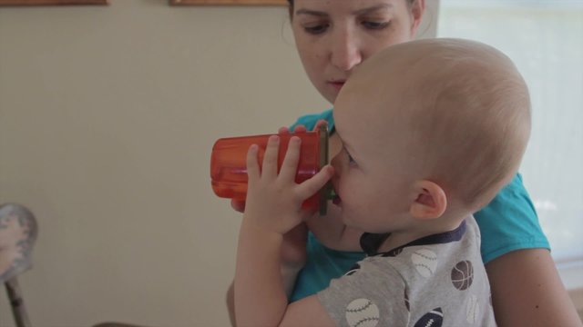a baby drinking from sippy