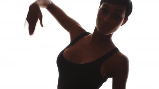 Black woman dancing in slow motion on white background