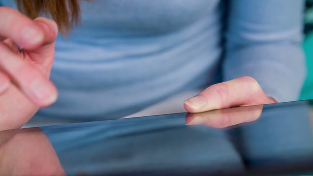 Typing on tablet computer close up slow motion