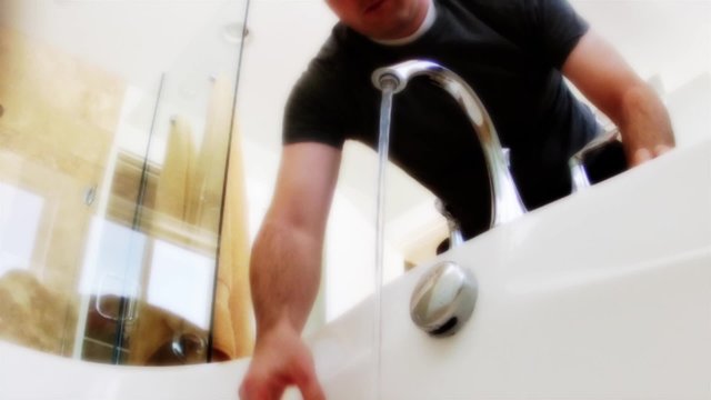 a man fills bathtub
