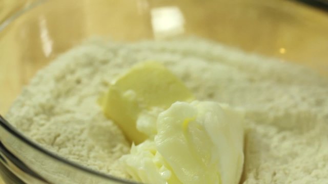woman putting butter in pie crust