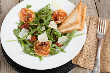 Salad with pancetta, parmesan cheese and dried tomatoes.
