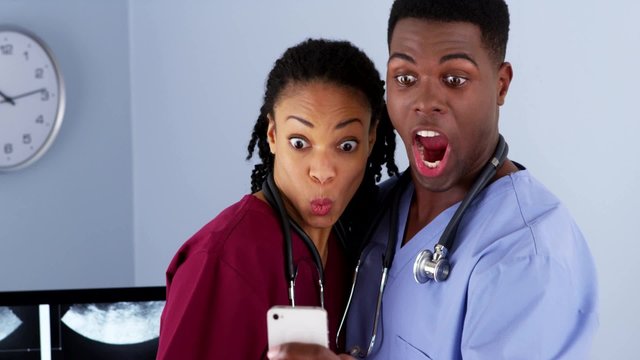 African American medical doctors taking wacky selfies together