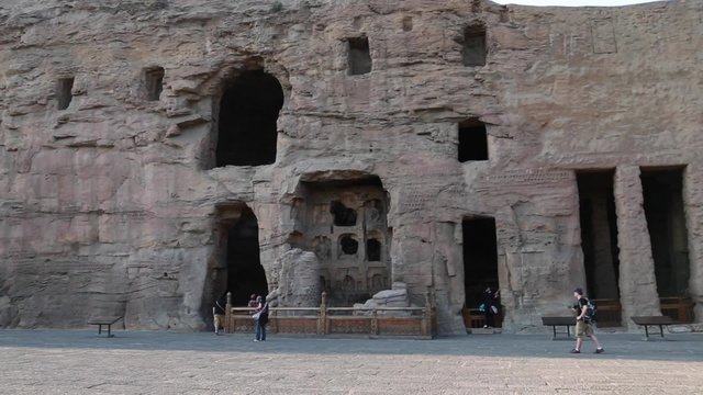 people in the yungang grottoes in datong china