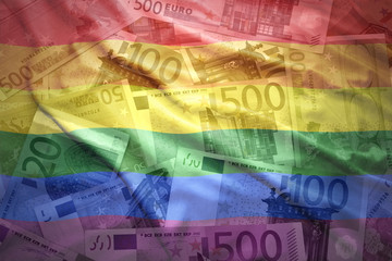 colorful waving gay flag on a euro money background