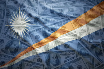 colorful waving Marshall Islands flag on a american dollar money background