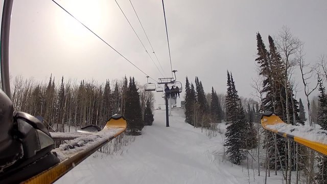 riding a ski lift low shot by skis