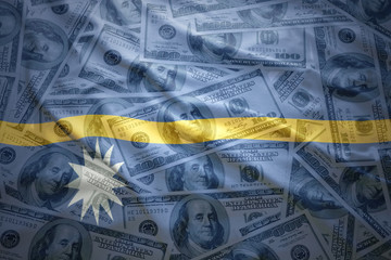 colorful waving nauru flag on a american dollar money background