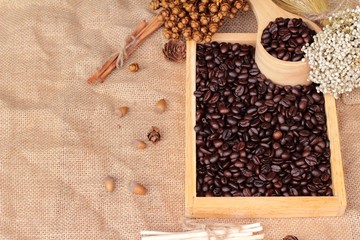 Roasted coffee beans on sack brown background.