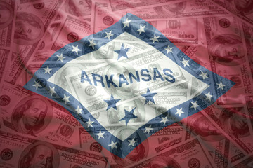 colorful waving arkansas state flag on a american dollar money background © luzitanija