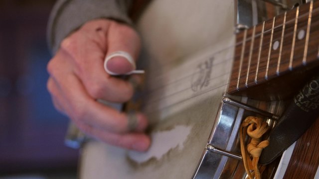 Man playing the banjo in a band close up