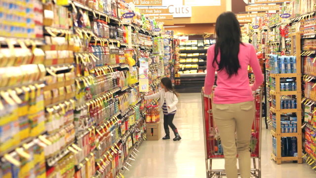 Mother And Daughter Shopping In Supermarket