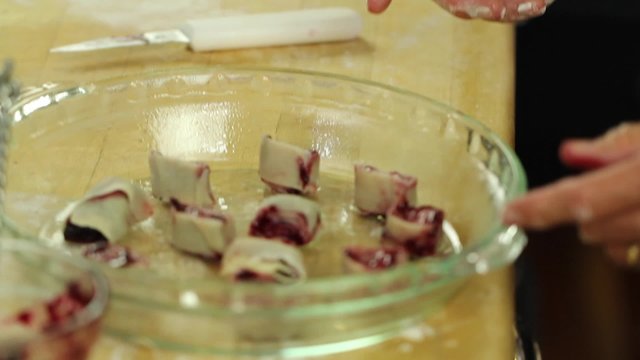 woman making tasty berry pie pastries