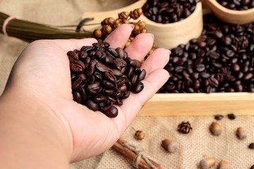 Roasted coffee beans on sack brown background.