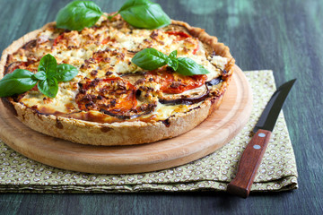 Aubergine, tomato and cheese quiche on board