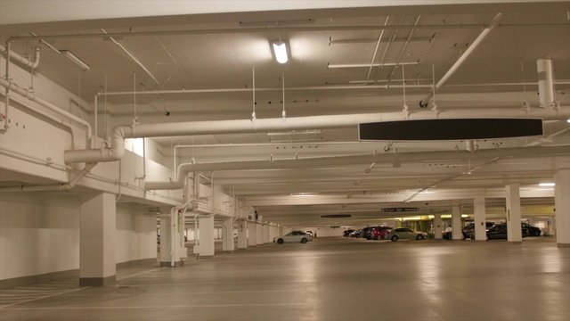 People and cars in the parking garage