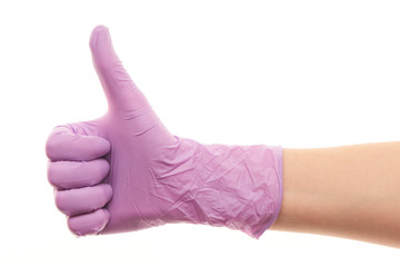 Doctor's hand in purple surgical glove showing thumbs up sign
