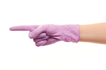 Female doctor's hand in purple surgical glove pointing on something