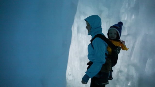 families walking in an ice castle
