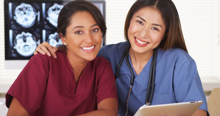 Happy team of medical doctors smiling and laughing at camera