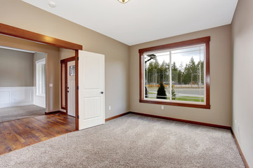 simple empty room with lots of space and carpet.