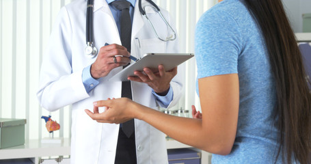 Chinese patient talking to hispanic doctor