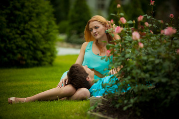 Obraz premium love story, love, in love with a man, a pretty girl walk in the park, mutual feelings, flowers, summer, trees, beautiful feeling