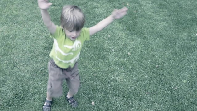 a young boy doing jumping jacks
