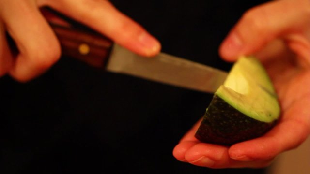 slicing an avacodo on mexican salad