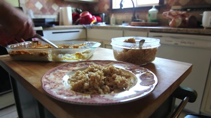 A man eating leftovers
