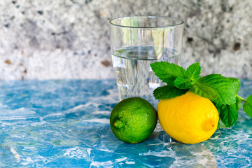 Citrus fruits and a glass of water