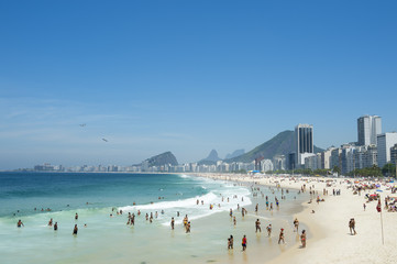 Obraz premium Scenic view of Copacabana Beach shore with skyline of Rio de Janeiro Brazil