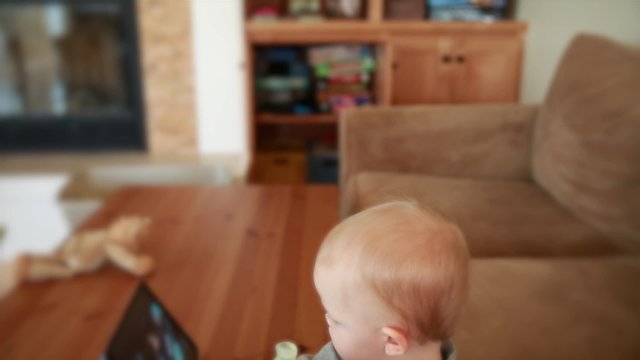 little boy watching a movie on a tablet