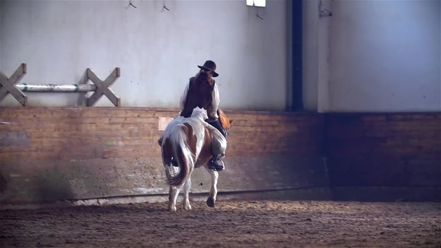Woman in Cawboy Clothes Riding Horse Slow Motion