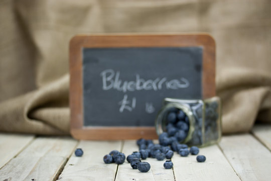 Blueberries spilt from a jar