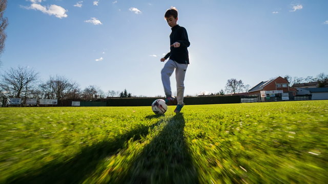 Active soccer player trying to dribble camera