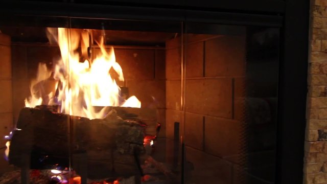 A Jib Shot Of A Roaring Fireplace And Mantel