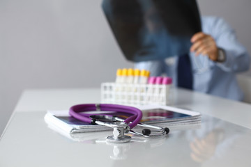 Medical doctor  sitting at table and looking patients roentgen