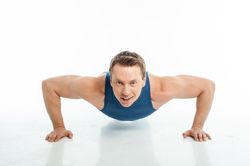 Fototapeta premium Handsome young male athlete is working out